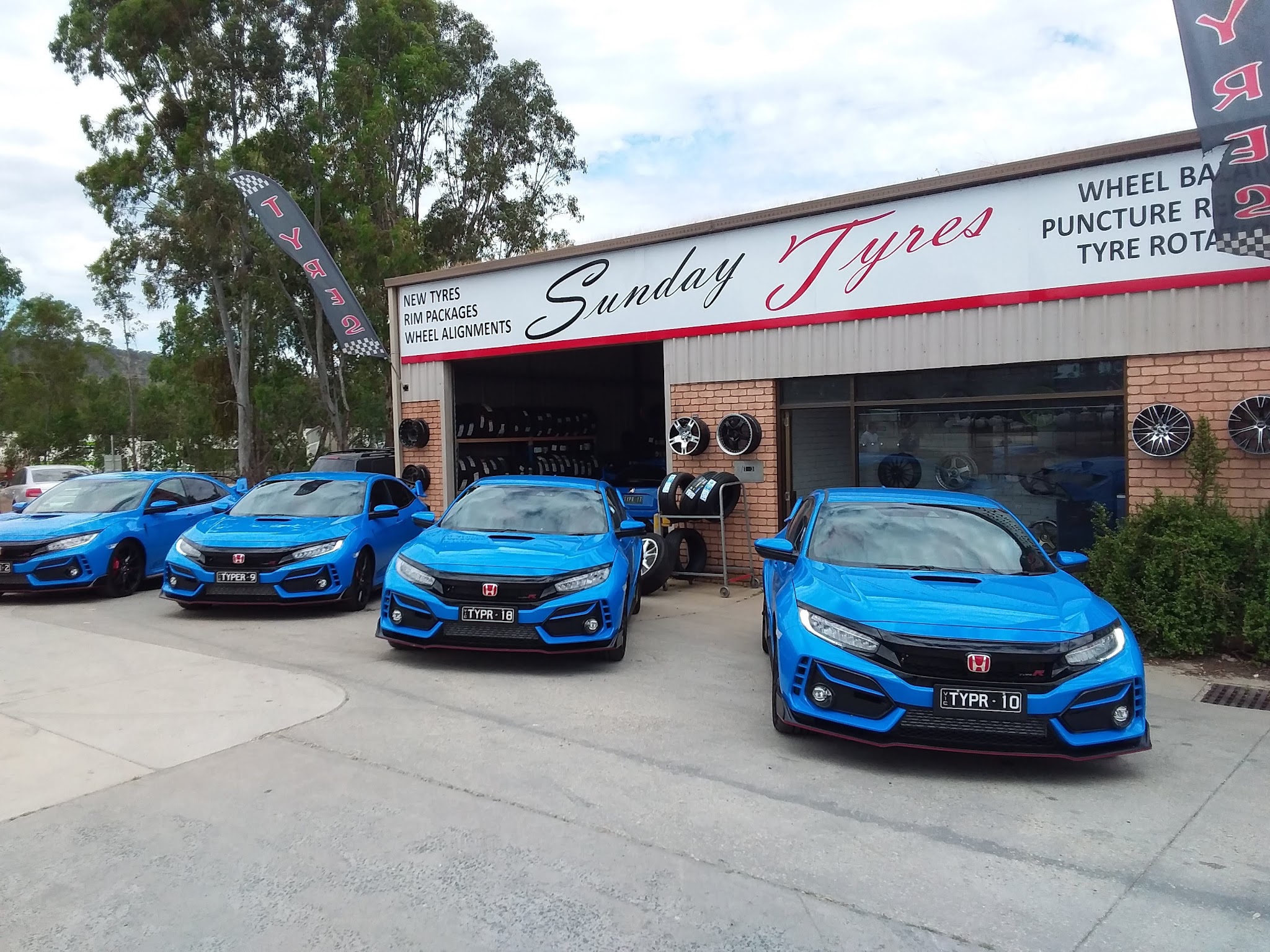 Four blue Honda Civic Type Rs lined up outside the Sunday Tyres workshop