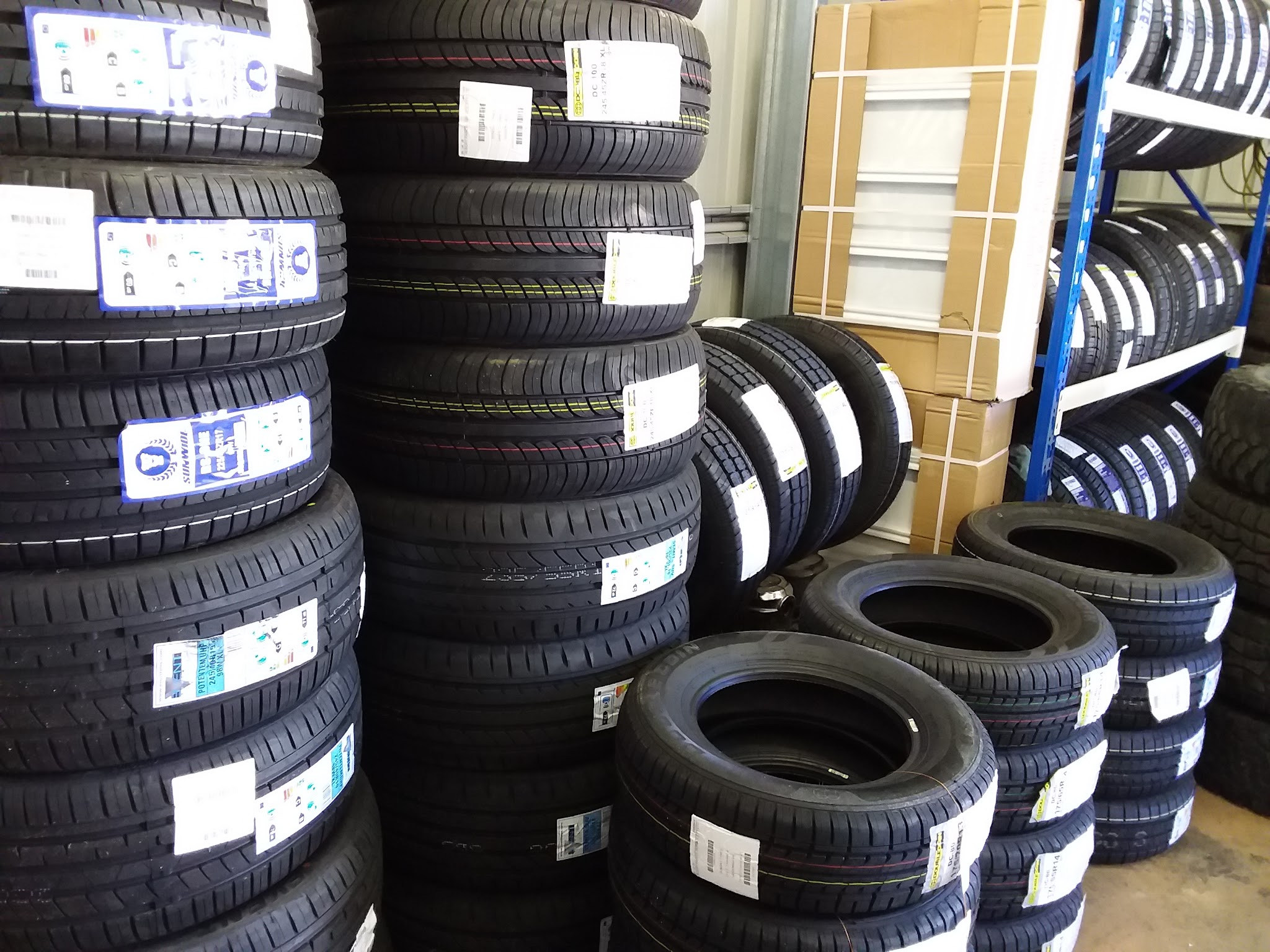 Racks of new tyre stock inside the Sunday Tyres store